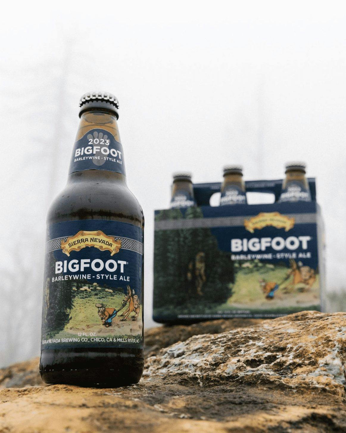 A bottle of Bigfoot sitting next to a 6-pack