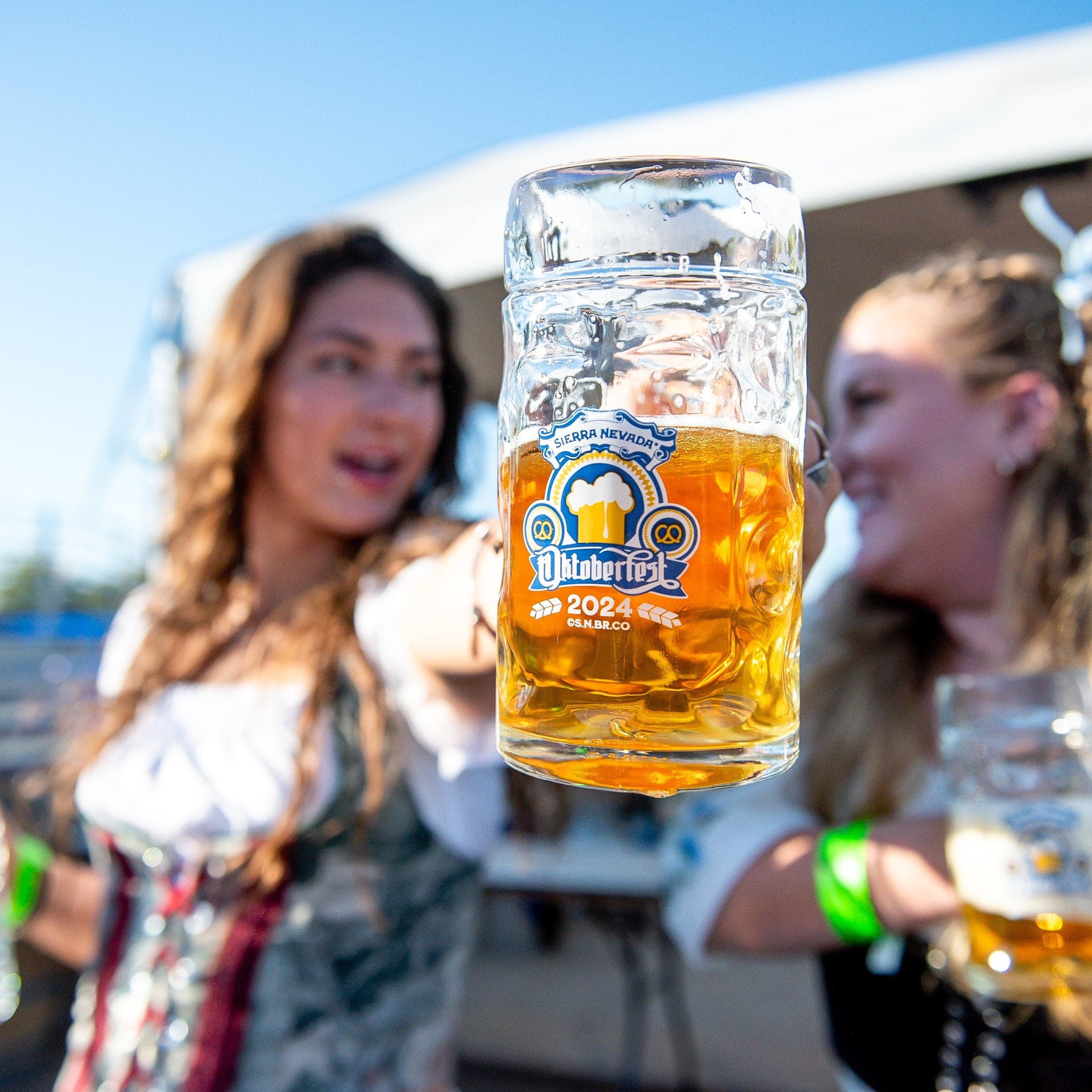 Sierra Nevada 2024 Oktoberfest glass stein held by an Oktoberfest attendee