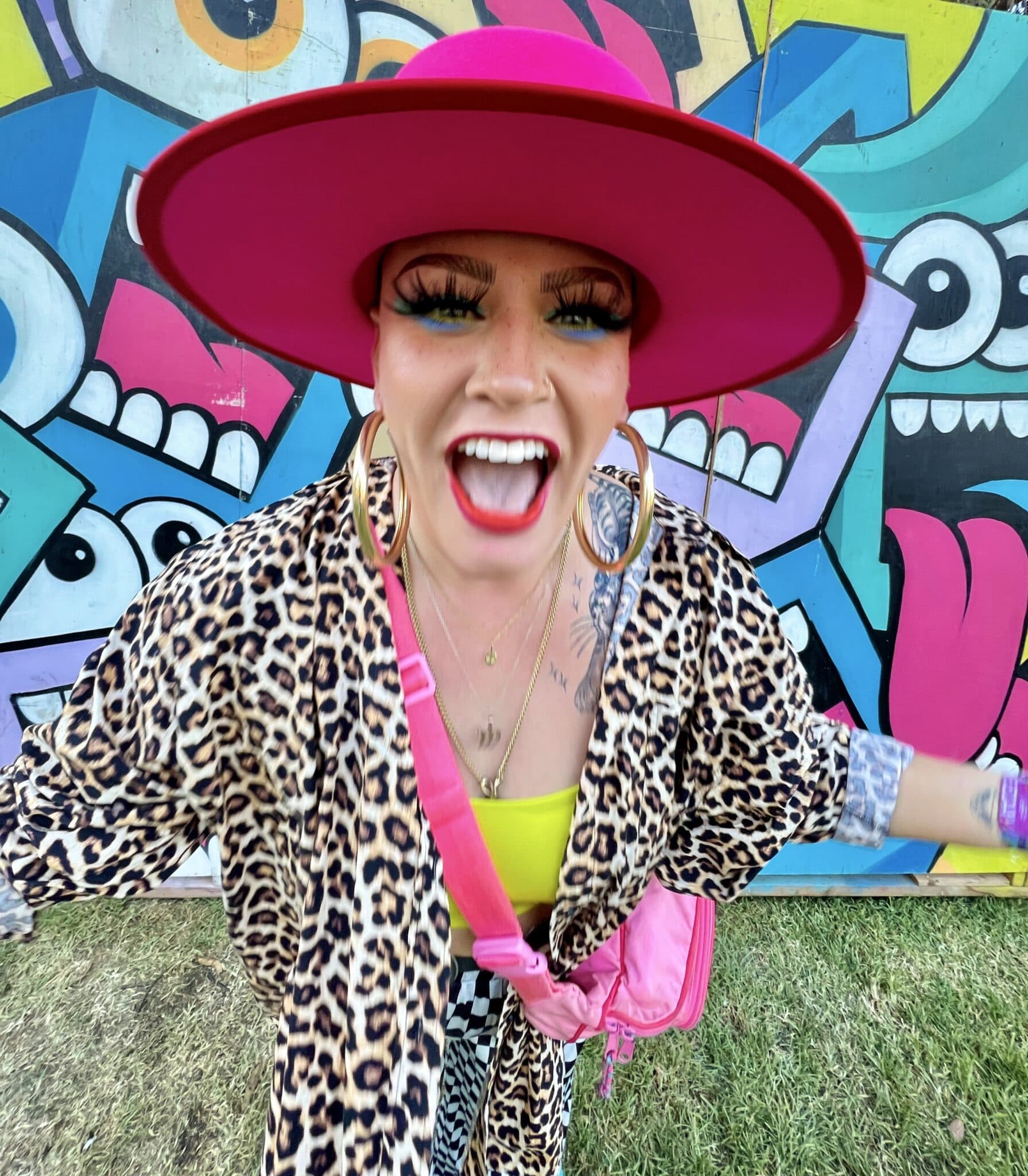 Girl smiling in front of a colorful wall