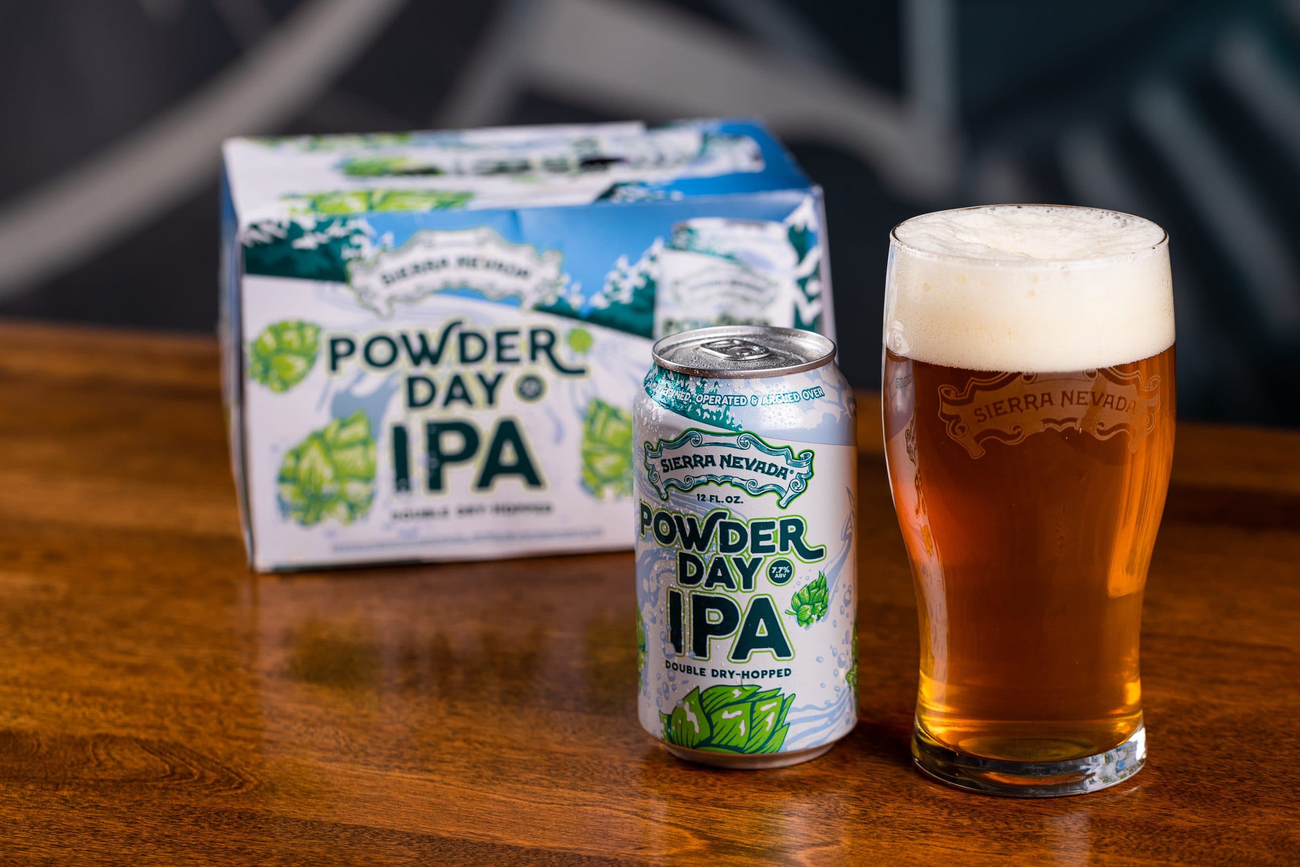 Pack of Powder Day IPA beer and pint glass
