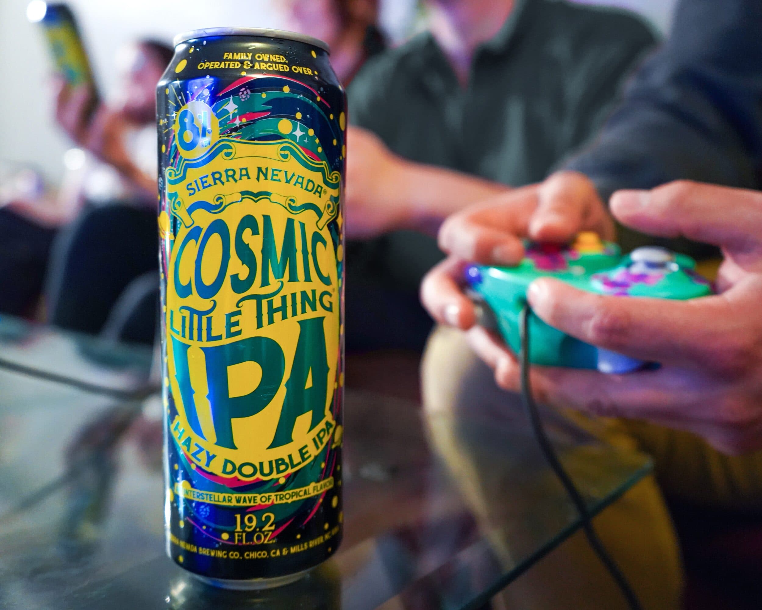 Cosmic Little Thing on table while people play video games