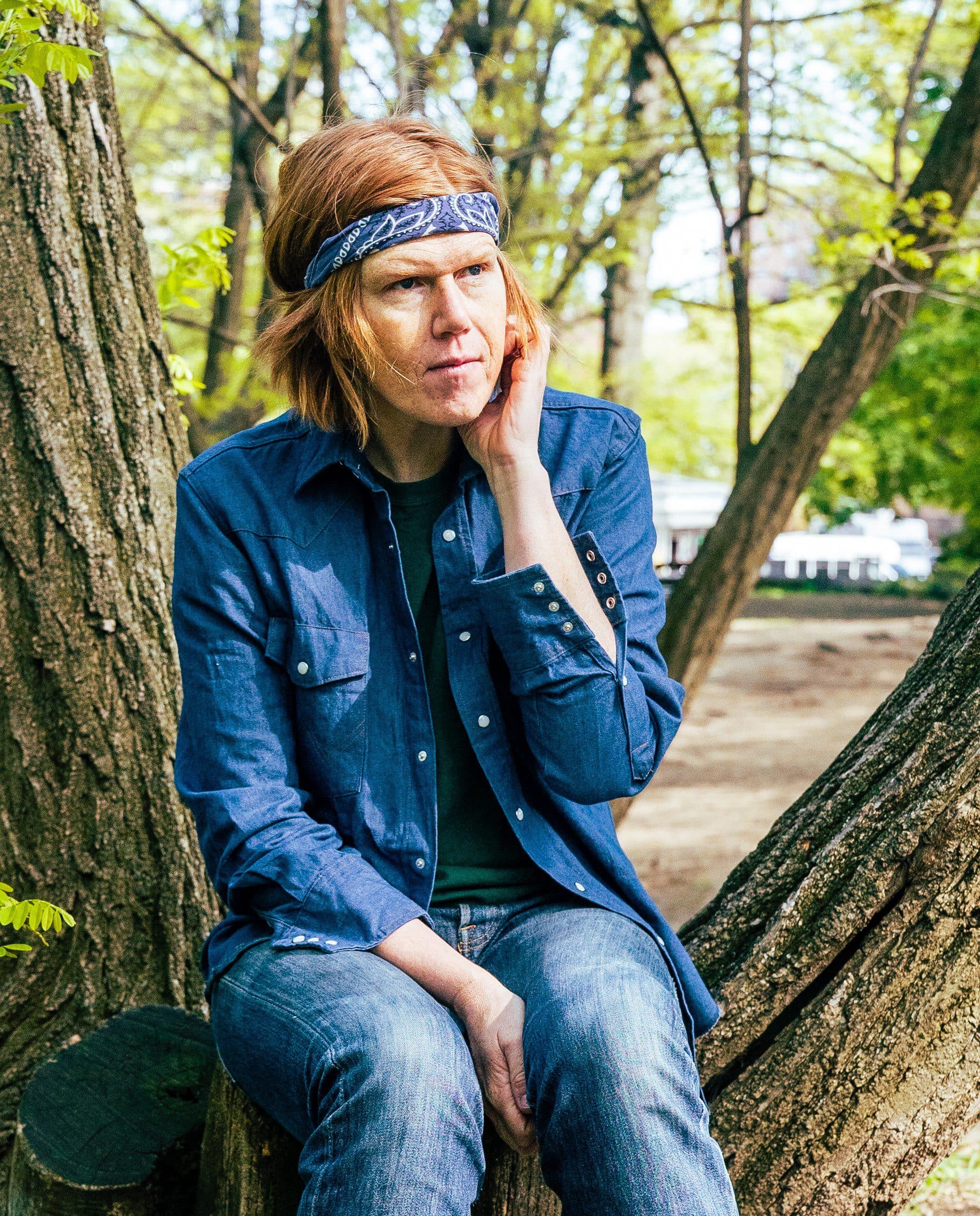 Brett Dennen sitting on tree