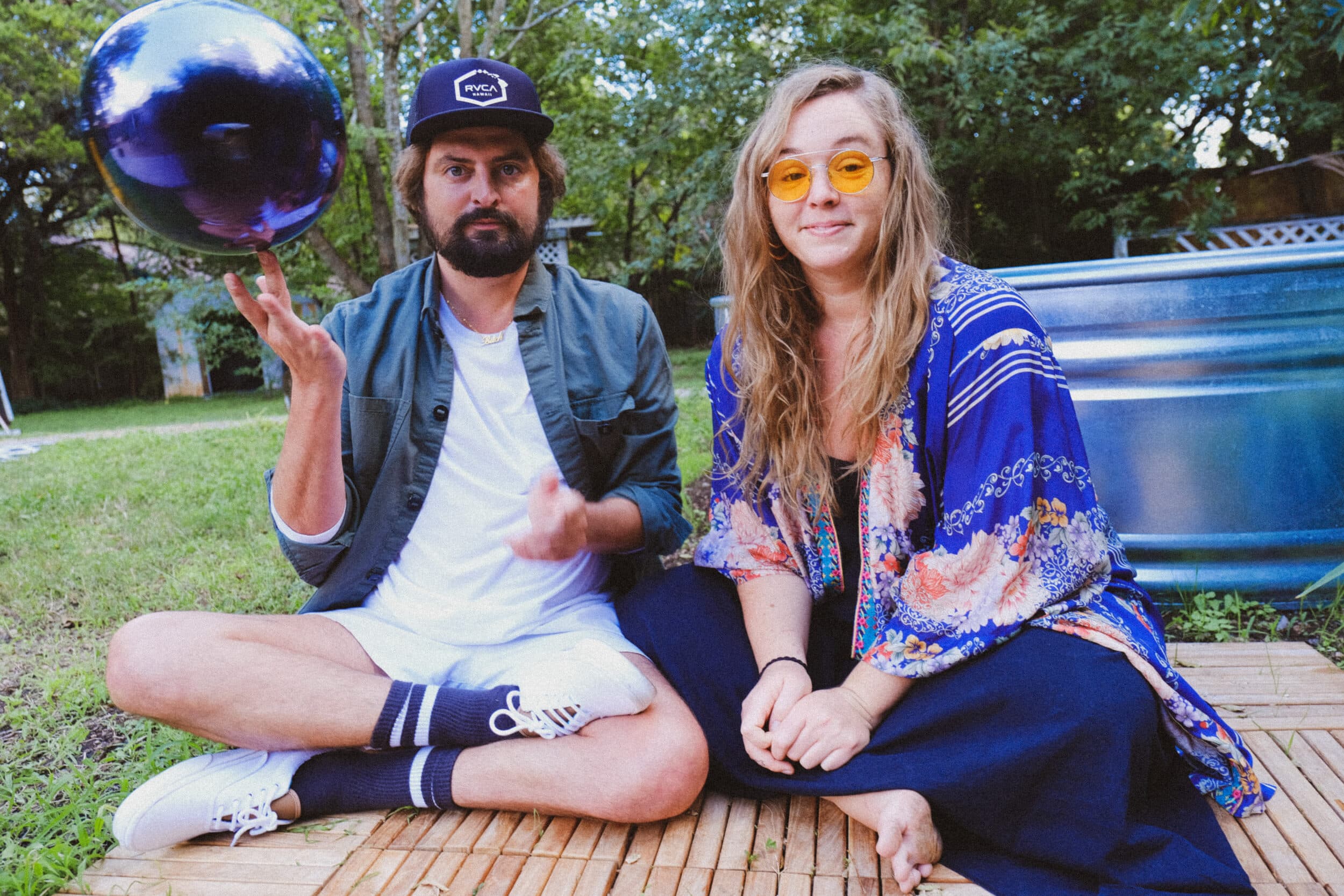 Wild Child band members sitting on grass