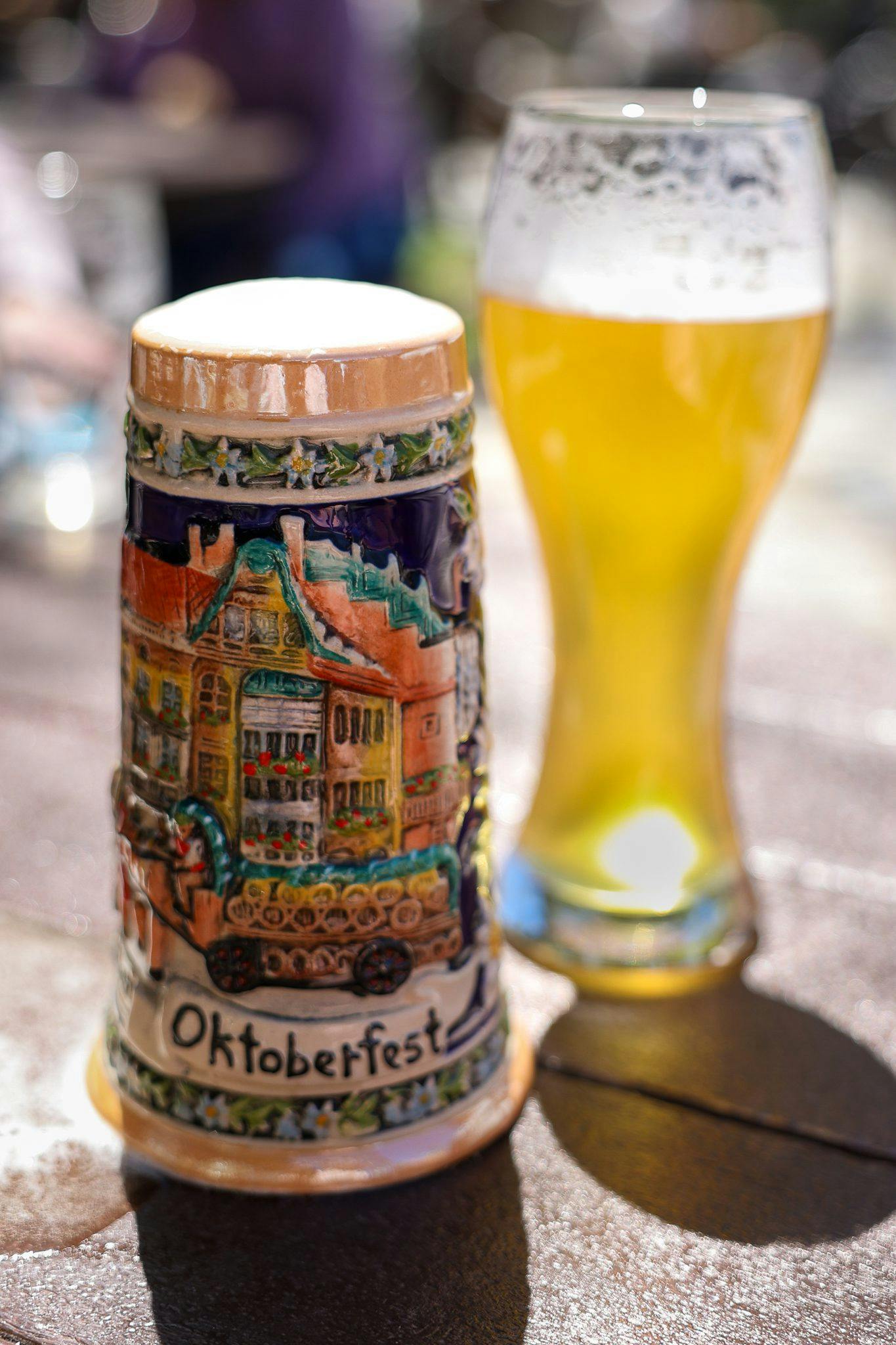 Oktoberfest beer in pint glass and stein on table outside