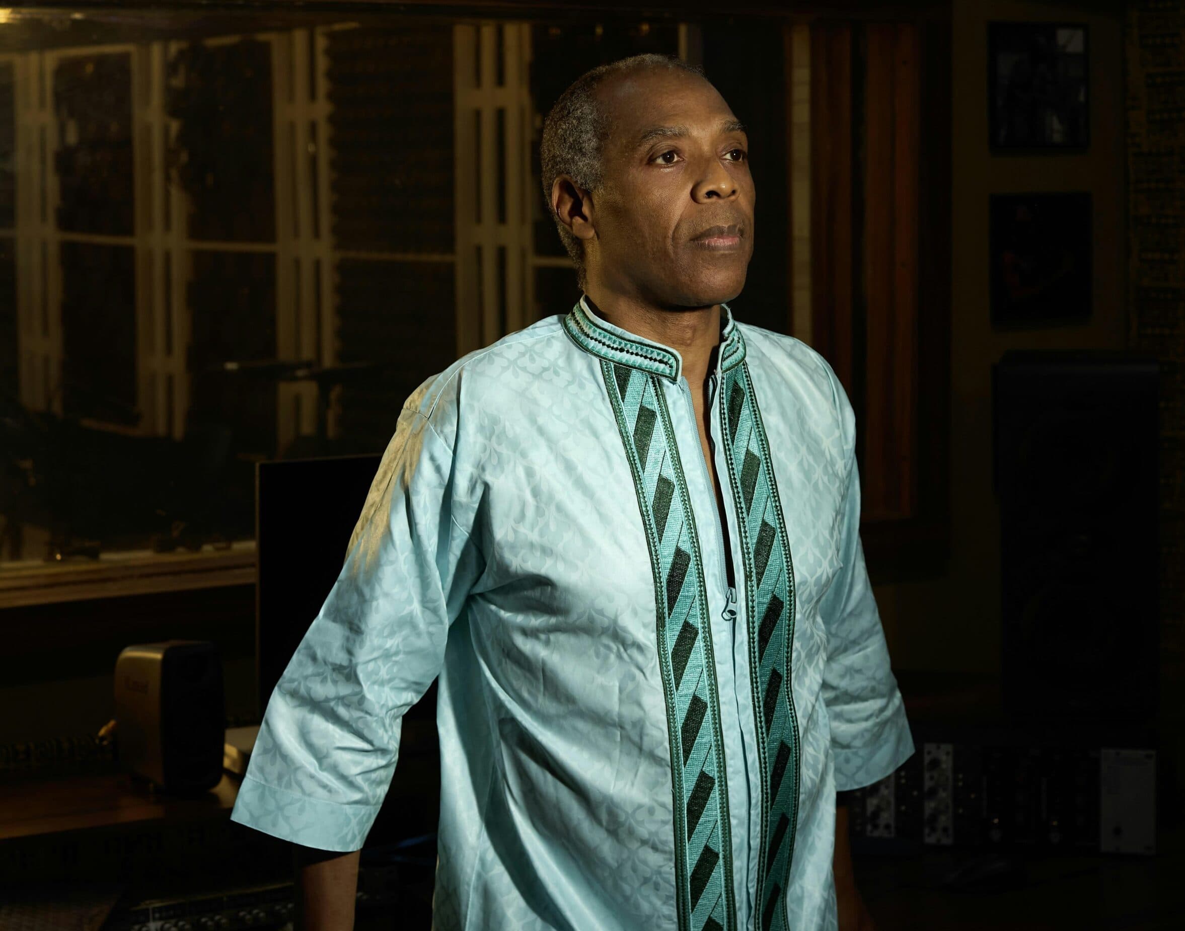 Femi Kuti standing around looking away from the camera