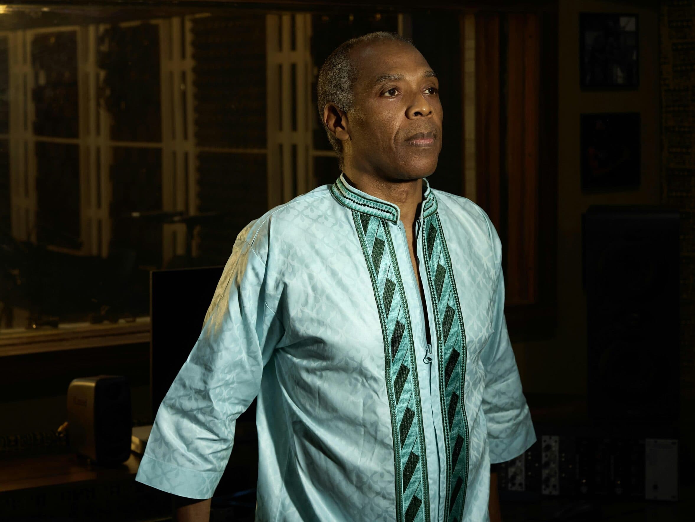 Femi Kuti standing and looking away from the camera