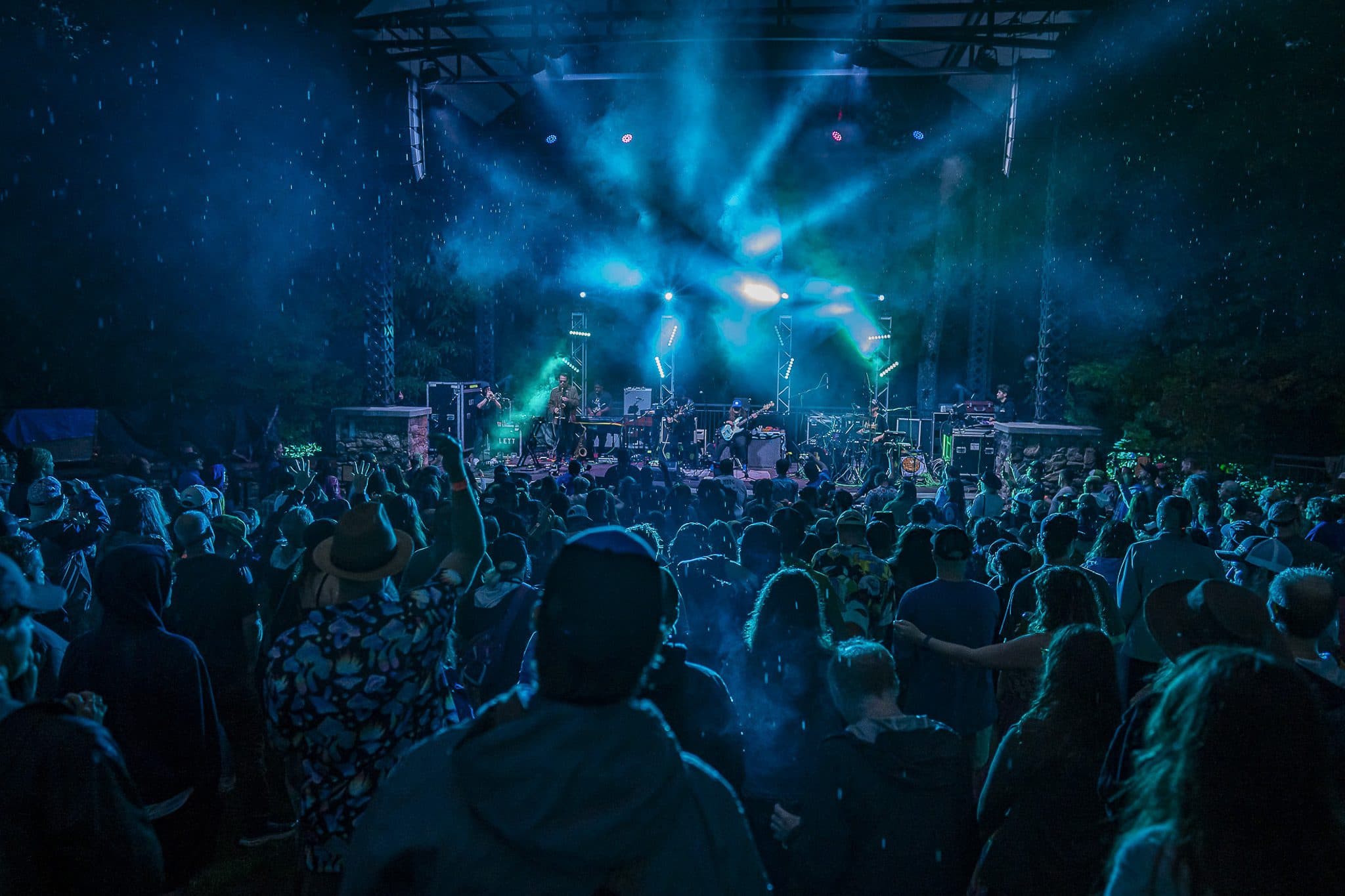 Crowd and light show during nighttime event at Sierra Nevada