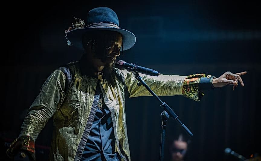 Fantastic Negrito pointing to the crowd while on stage.