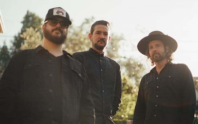 The Record Company band in black outfits looking at the camera