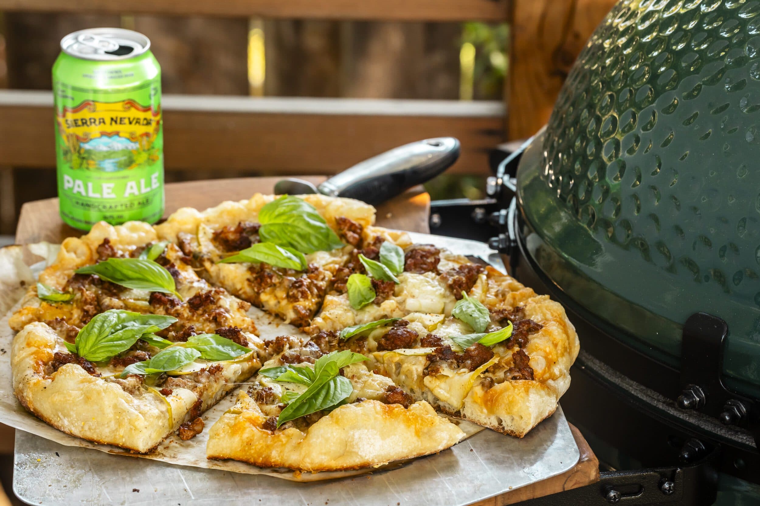 Pale Ale Flatbread on a table outside next to a Big Green Egg BBQ