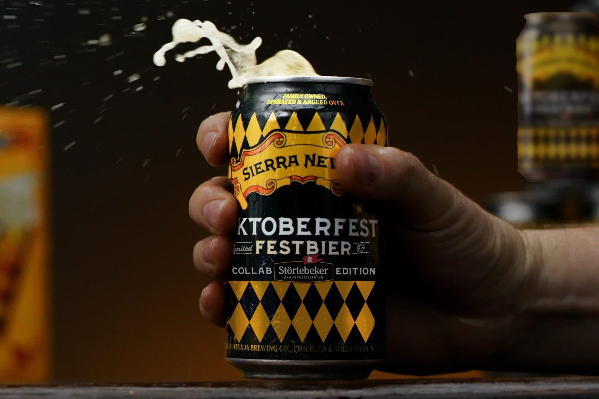 A 12oz can of Oktoberfest held in hand with foam emerging from the top of the can