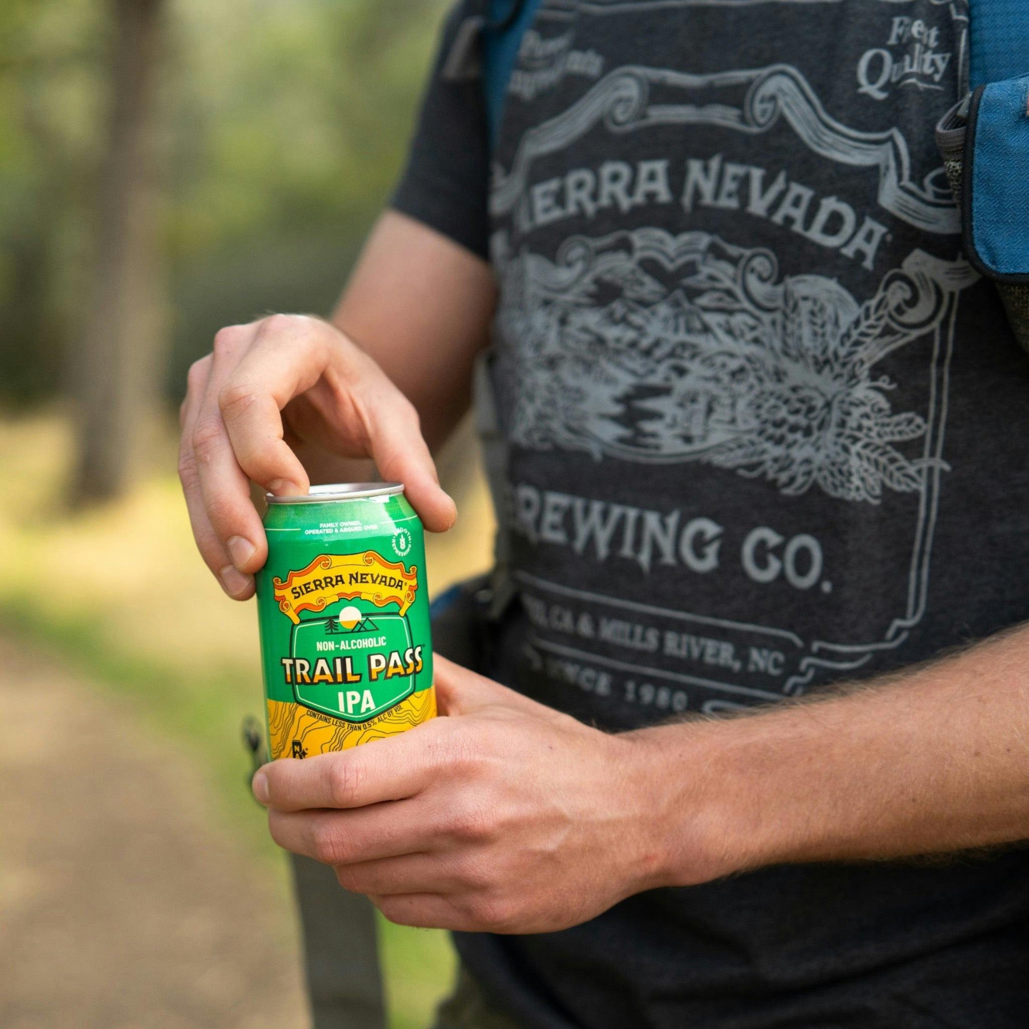 Sierra Nevada Brewing Co. Trail Pass IPA Non-Alcoholic Brew - A hiker pauses to crack open a can of Trail Pass IPA