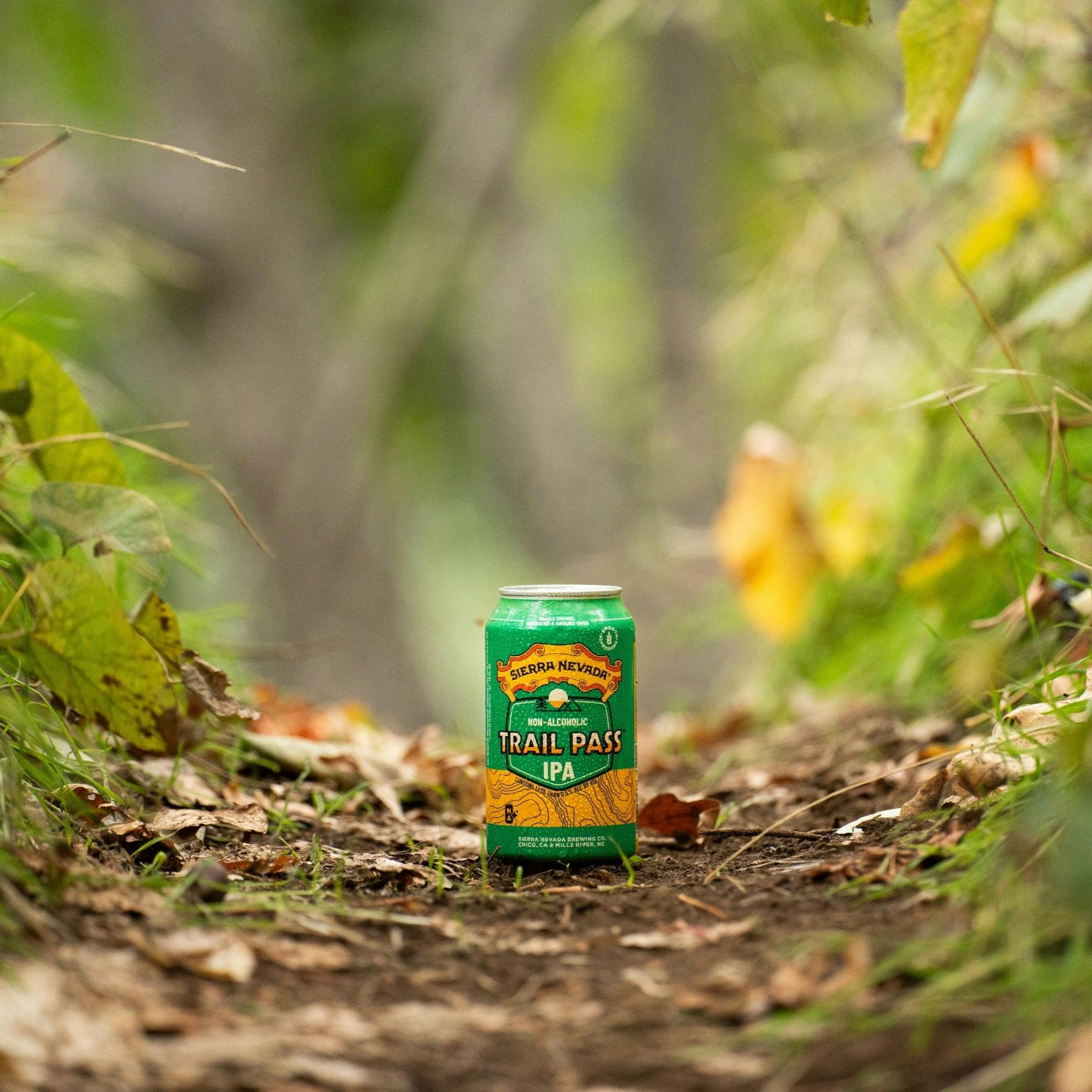 Sierra Nevada Brewing Co. Trail Pass IPA Non-Alcoholic Brew - A refreshing can of Trail Pass IPA sits in the middle of a wooded hiking trail.