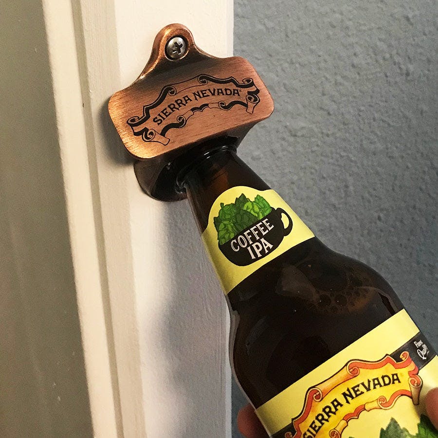 Sierra Nevada wall mounted bottle opener being used to crack open a bottle of Coffee IPA