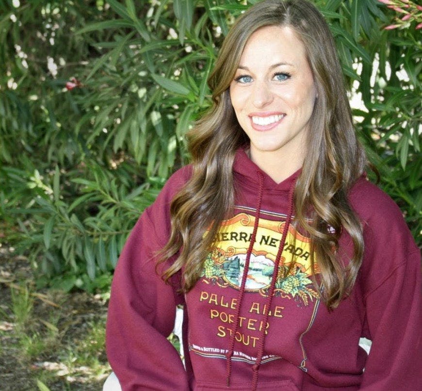 Woman with brown hair wearing Pale Porter Stout maroon hoodie