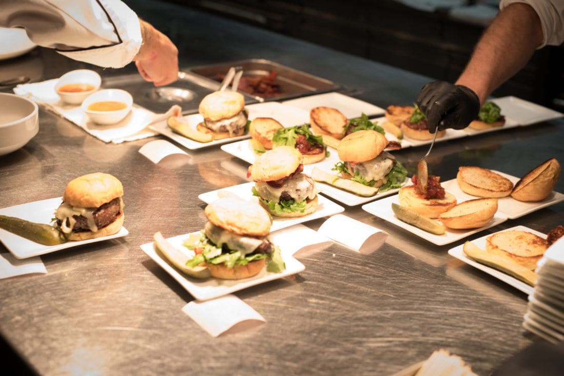 burgers being lined up and prepared