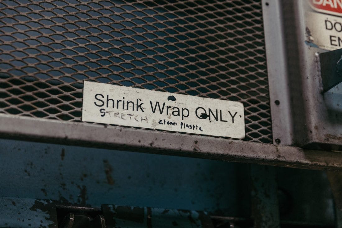 "shrink wrap only" sign
