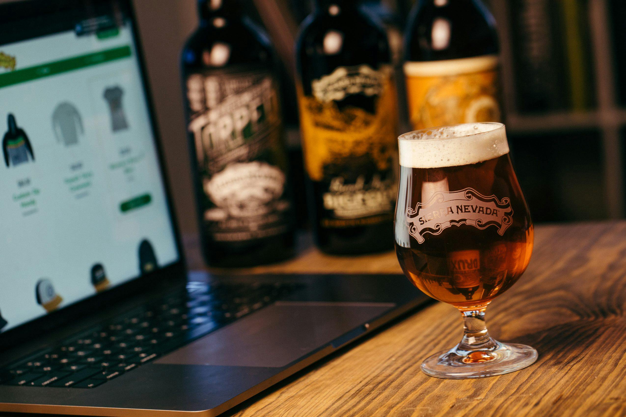 Sun rays shining through several bottles of Sierra Nevada Brewing Company beer and a laptop computer