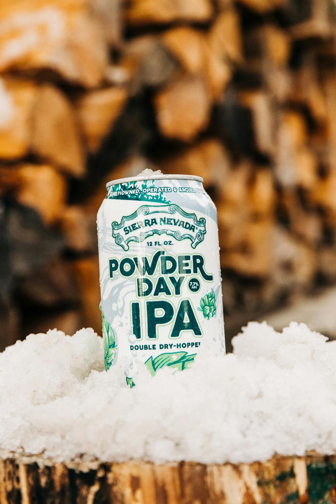 Powder Day IPA beer can on powder