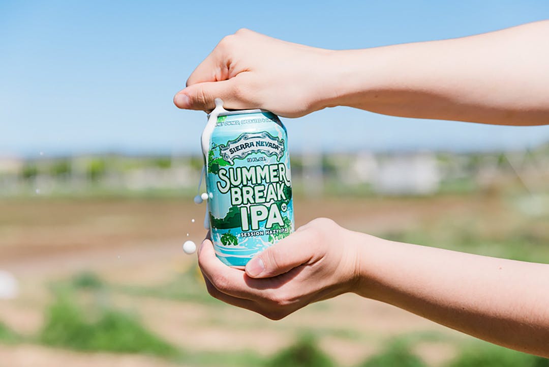 Opening can of Summer Break IPA beer outside