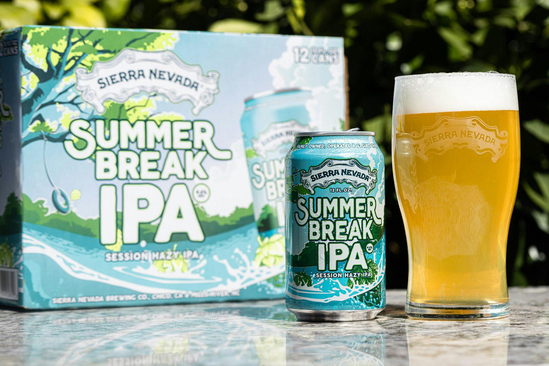 Pack of Summer Break IPA beer cans next to pint glass