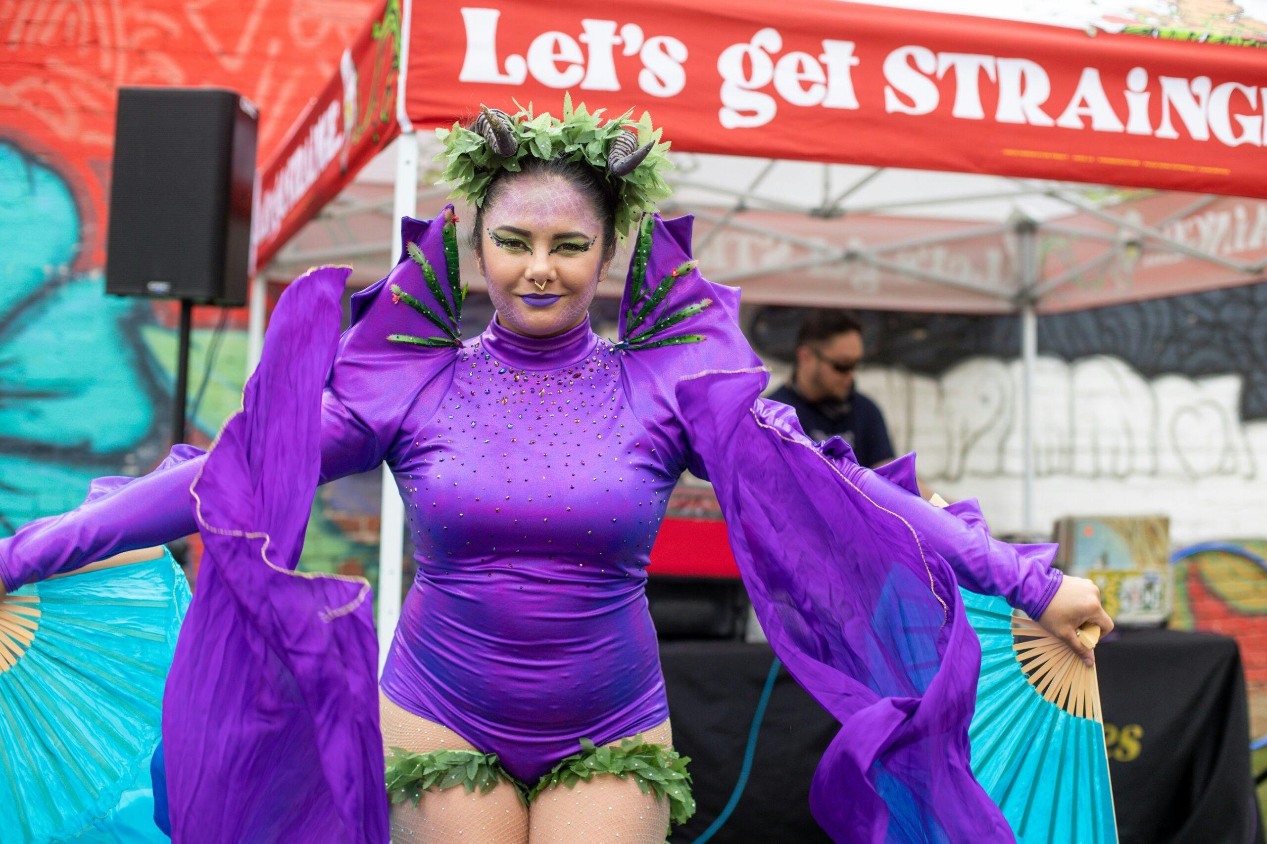 Festival goer dressed in purple costume