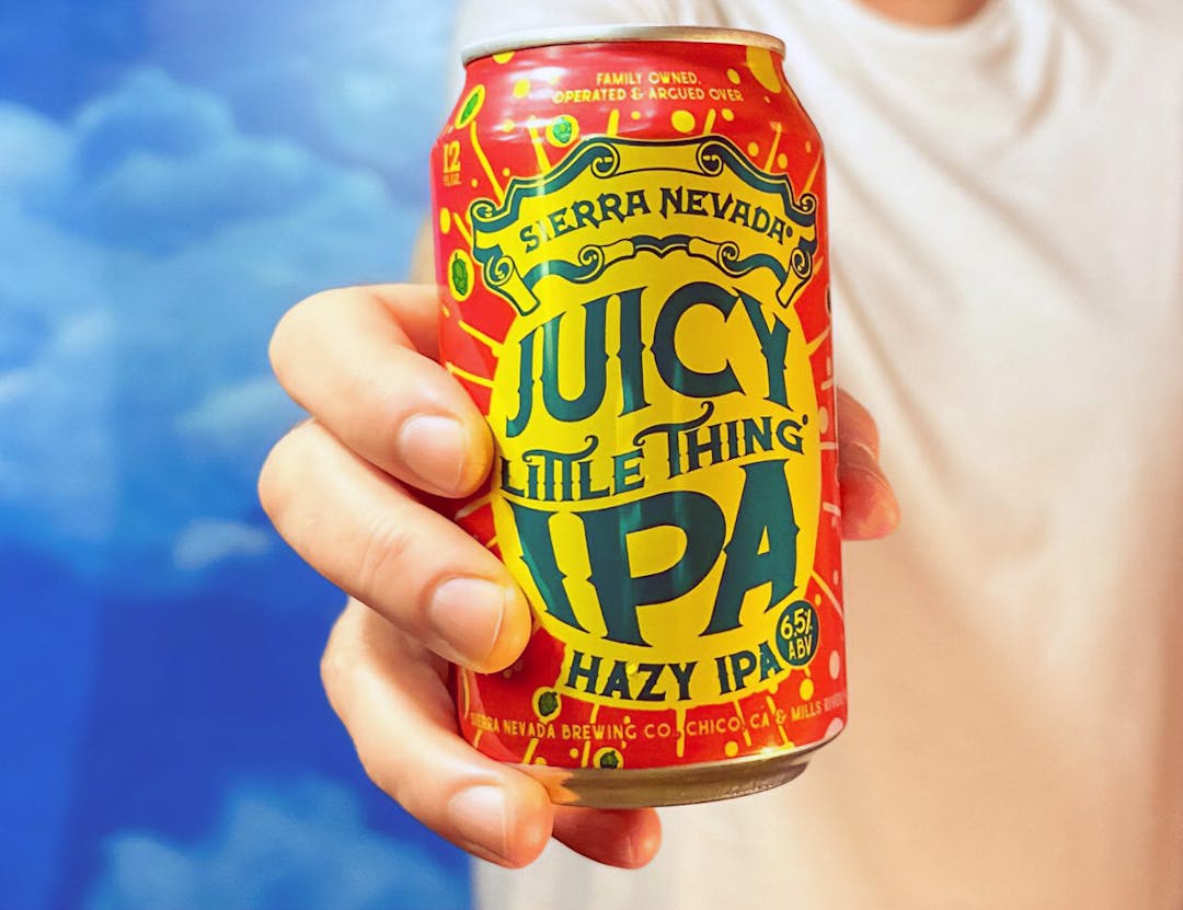 Person holding can of Juicy Little Thing