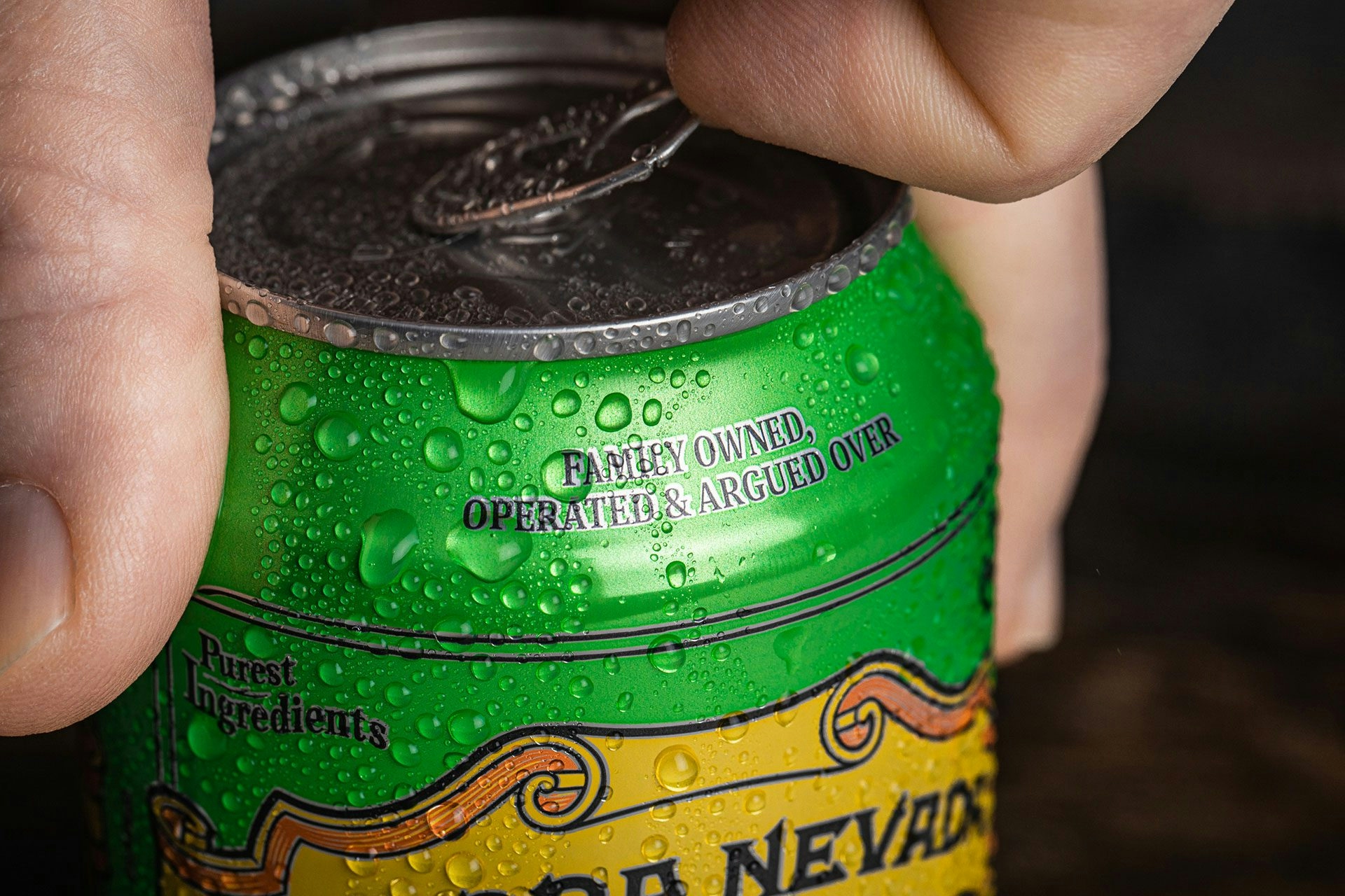 Hand opening the tab on a can of Sierra Nevada Pale Ale