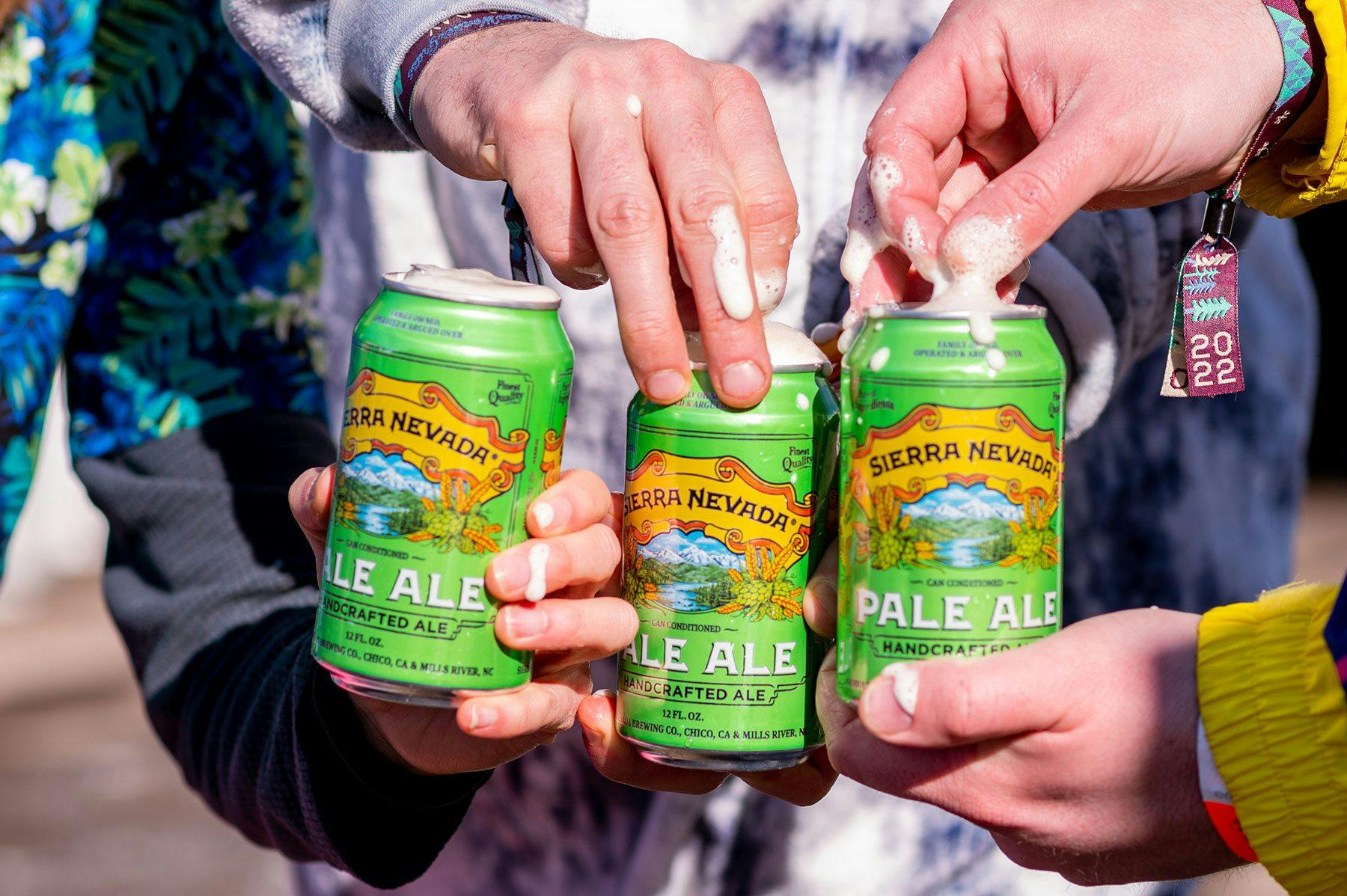 hands opening cans of Pale Ale