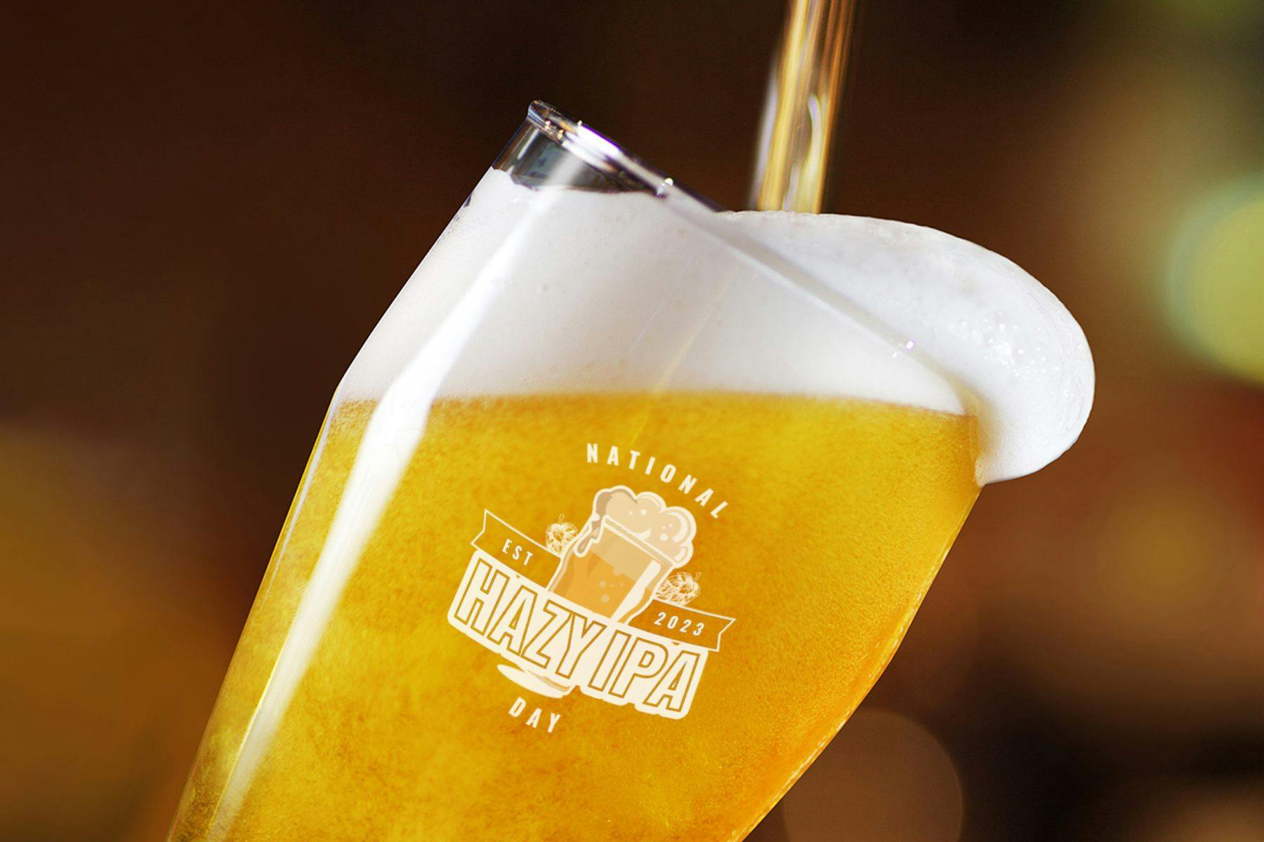 Beer filling a glass that shows the logo for National Hazy IPA Day