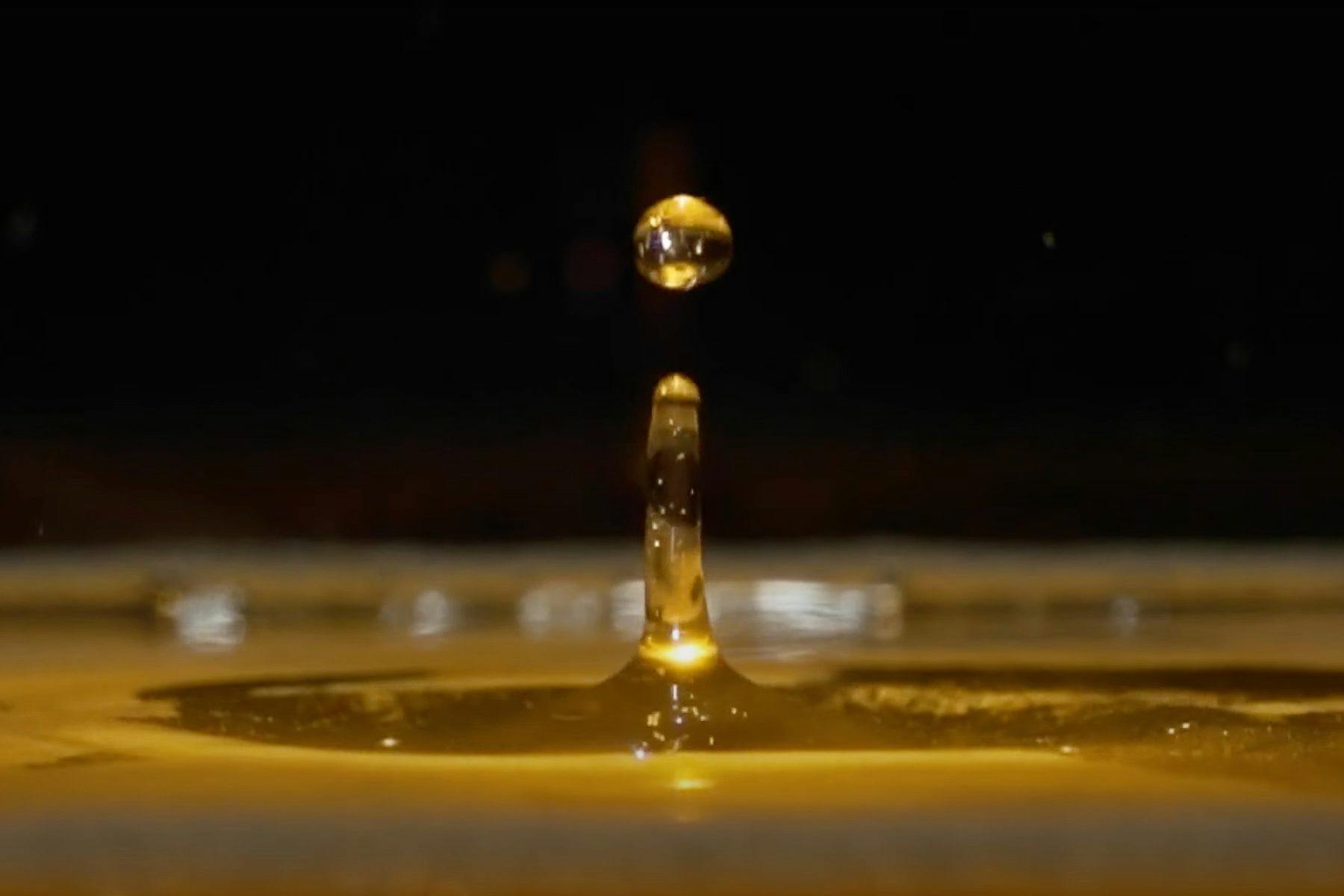 A drop of beer jumping into the air after being poured